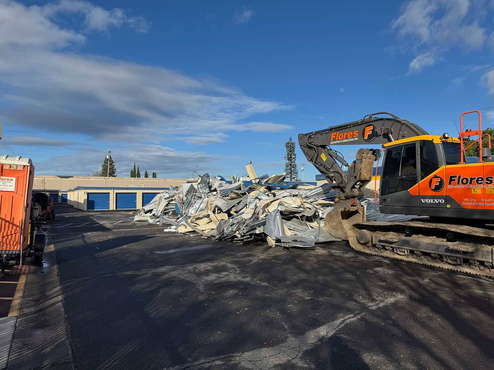 Excavator removing a commercial structure during demolition